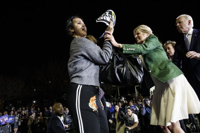 Biden's wife, Jill, blocks a protester who charged the stage during his Super Tuesday speech in Los Angeles in March 2020. The protester was holding a sign that said 