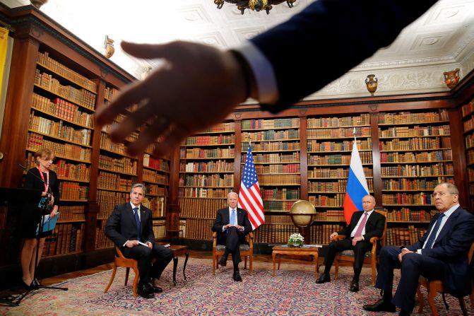 A security officer asks the media to step back at the start of a summit between Biden and Russian President Vladimir Putin in June 2021. Seated from left are US Secretary of State Antony Blinken, Biden, Putin and Russian Foreign Minister Sergey Lavrov. The summit, held in Geneva, Switzerland, was the first meeting of Biden and Putin since Biden was elected President.