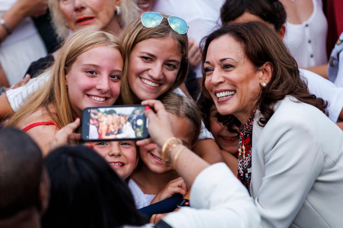 Vice President Harris takes a photo with guests during a 4th of July event on the South Lawn of the White House on July 4.