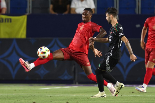 AFC Bournemouth midfielder Jaidon Anthony, left, blocks a kick by...