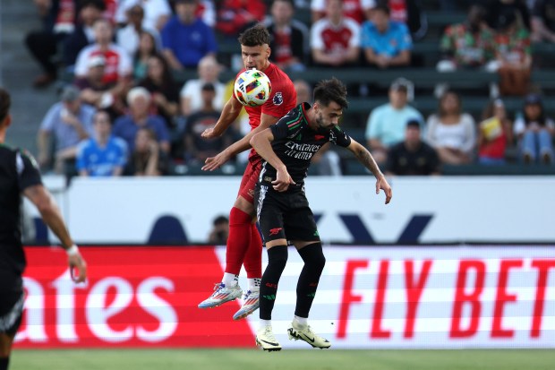 AFC Bournemouth defender Milos Kerkez, left, vies for the ball...