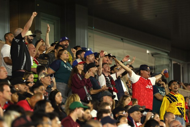 A group of fans chant a song during the second...