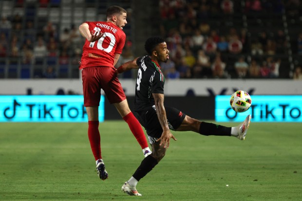 Arsenal forward Gabriel Jesus, right, tries to recover the ball...