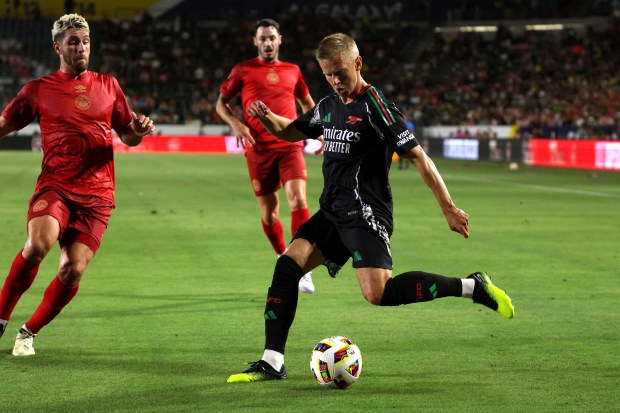 Arsenal’s Alex Zinchenko, right, kicks the ball during the second...