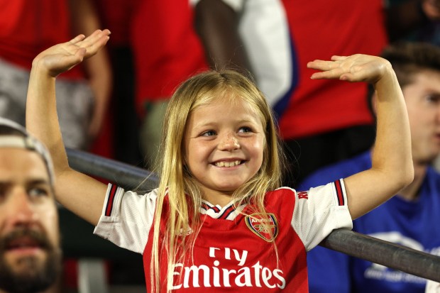 A fan waves her arms during the second half of...