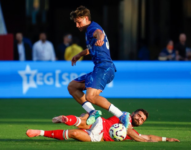 Wrexham AFC's Elliot Lee (38) tackles Chelsea FC's Marc Guiu...