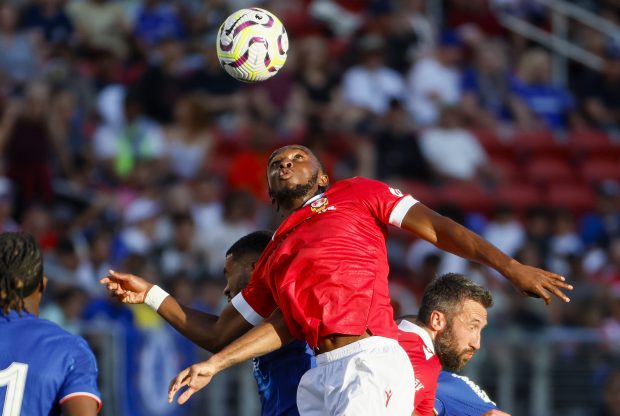 Wrexham AFC's Seb Revan (53) fights for the ball against...