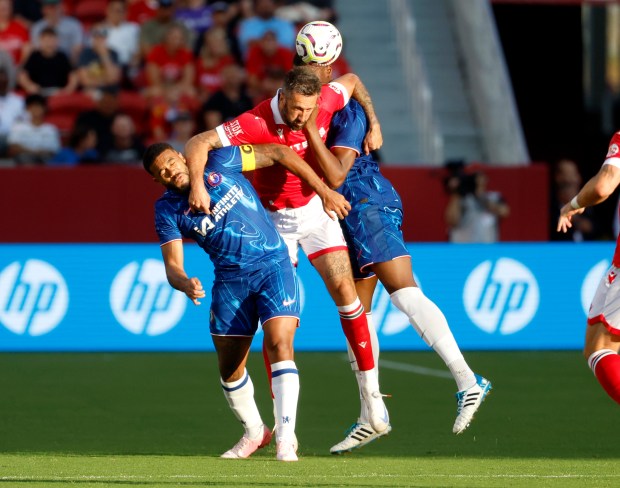 Wrexham AFC's Ollie Palmer (9), center, fights for the ball...