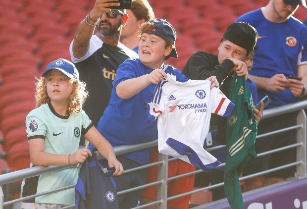 Chelsea FC fans try and get the attention of players...