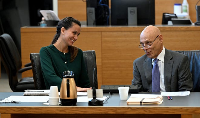 Ashley Benefield and attorney Neil Taylor laugh together bofore the voir dire portion of her trial for the second-degree murder of her estranged husband in 2020 at the Manatee County Judicial Center, July 22, 2024.