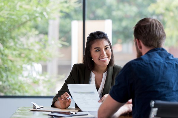 Insurance representative reviewing paperwork with client.