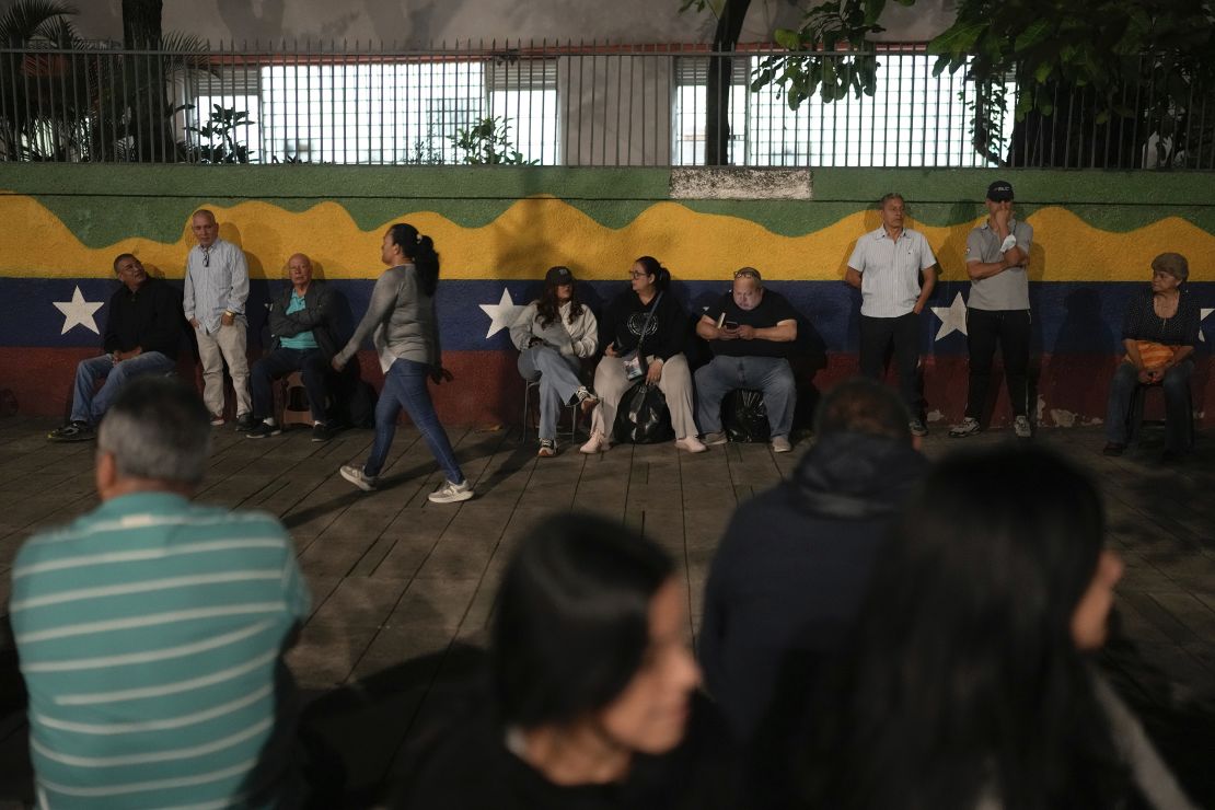 Voters line up prior to the opening of the polls for presidential elections in Caracas, Venezuela, Sunday, July 28, 2024.