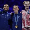 United States' Lee Kiefer, center, winner of the gold medal of the women's individual Foil competition, celebrates on the podium with silver medal winner United States' Lauren Scruggs, left, and bronze medal winner Canada's Eleanor Harvey during the Paris Olympics on Sunday.