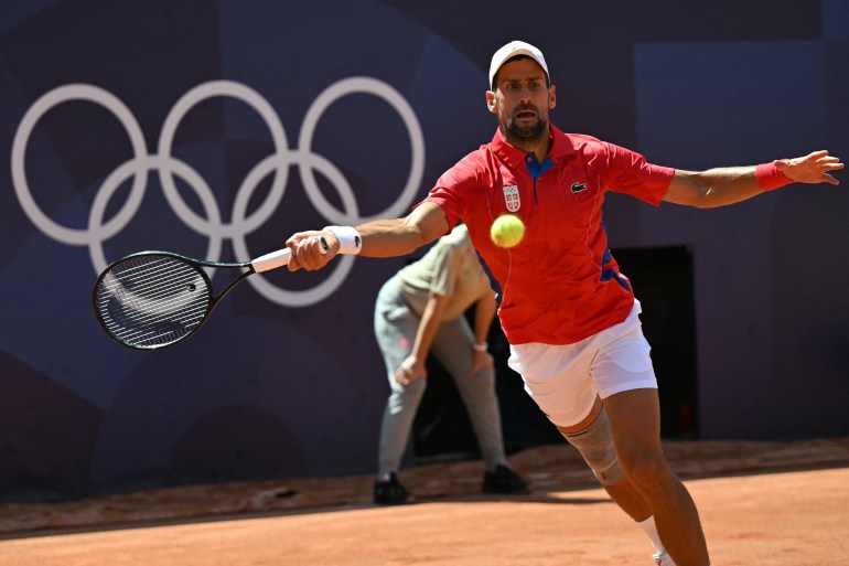 Tennis player strikes ball during match.