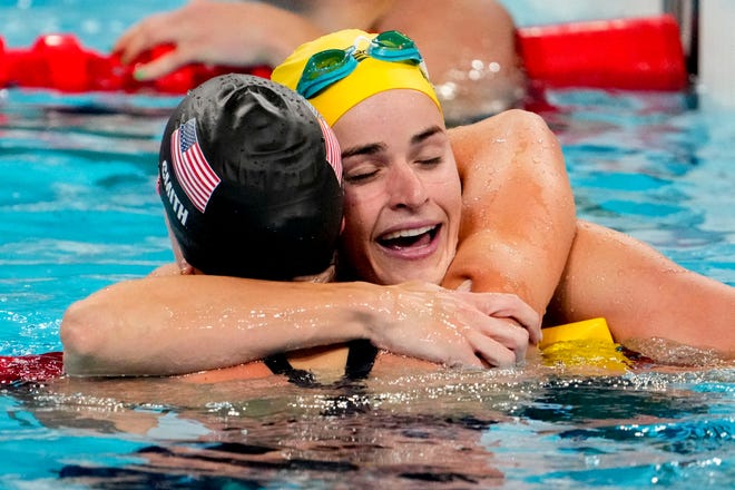 Regan Smith (USA) and Kaylee McKeown (Australia) embrace after the women’s 100-meter backstroke final. McKeown won gold and Smith won silver.