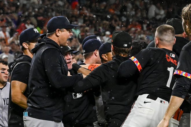 Jul 12, 2024; Baltimore, Maryland, USA; New York Yankees manager Aaron Boone (left) reacts and benched clear in the ninth inning of the game d against the Baltimore Orioles at Oriole Park at Camden Yards. Mandatory Credit: Tommy Gilligan-USA TODAY Sports