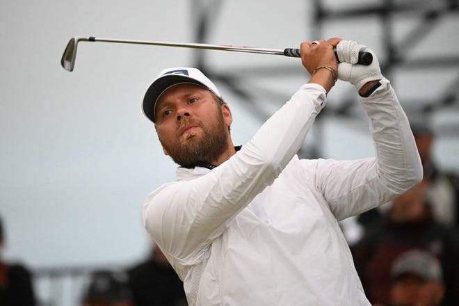 England's Daniel Brown watches his iron shot from the 17th tee on the opening day of the 152nd British Open Golf Championship at Royal Troon on the south west coast of Scotland on July 18, 2024.