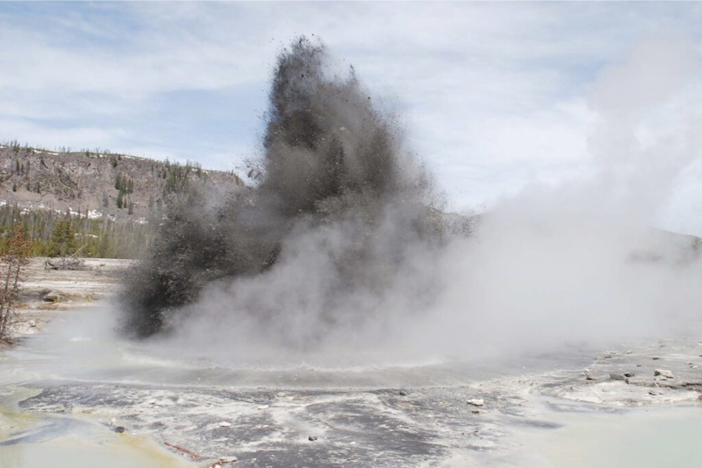 Hydrothermal explosion at Biscuit Basin in Yellowstone National Park. These types of events are the most likely explosive hazard from the Yellowstone Volcano. (Image via Public Domain / 2009 UNAVCO Earthscope Field Trip Participants)