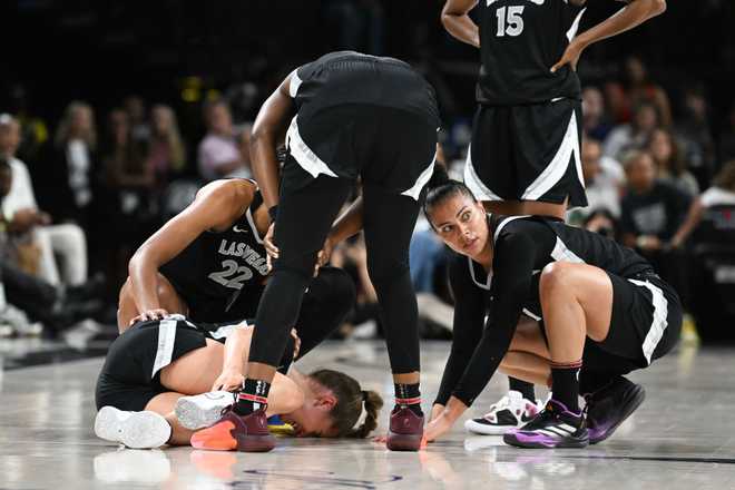 LAS VEGAS, NEVADA - JULY 16: A'ja Wilson #22, Chelsea Gray #12 and Alysha Clark #7 rush to Kate Martin #20 of the Las Vegas Aces after being injured against the Chicago Sky in the first half of their game at Michelob ULTRA Arena on July 16, 2024 in Las Vegas, Nevada. The Sky defeated the Aces 93-85. (Photo by Candice Ward/Getty Images)