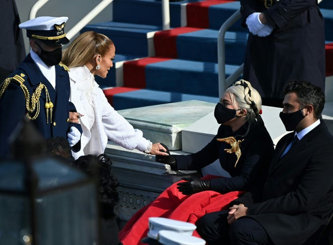 Jennifer Lopez greets Lady Gaga, flanked by Michael Polansky, right, as they both attend the inauguration of President Joe Biden on Jan. 20, 2021, at the U.S. Capitol in Washington, D.C.