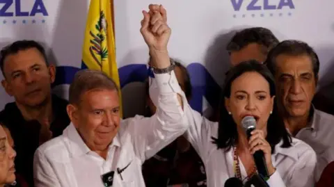 Reuters Venezuelan opposition leader Maria Corina Machado and opposition presidential candidate Edmundo Gonzalez hold a press conference after the electoral authority announced that Venezuelan President Nicolas Maduro has won a third term, during the presidential election, in Caracas, Venezuela July 29, 2024.