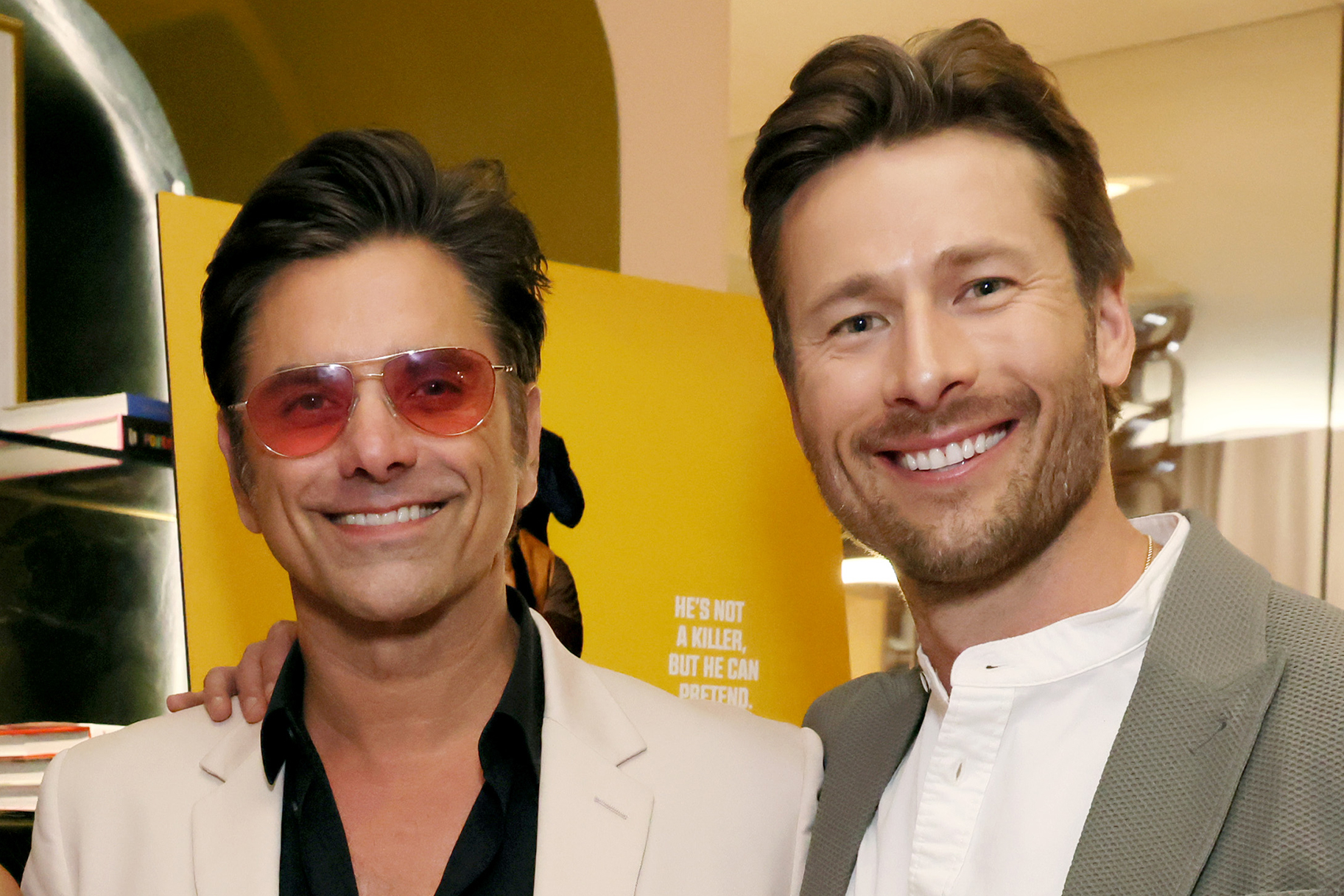 See Glen Powell Get His Makeup Done by John Stamos (VIDEO)