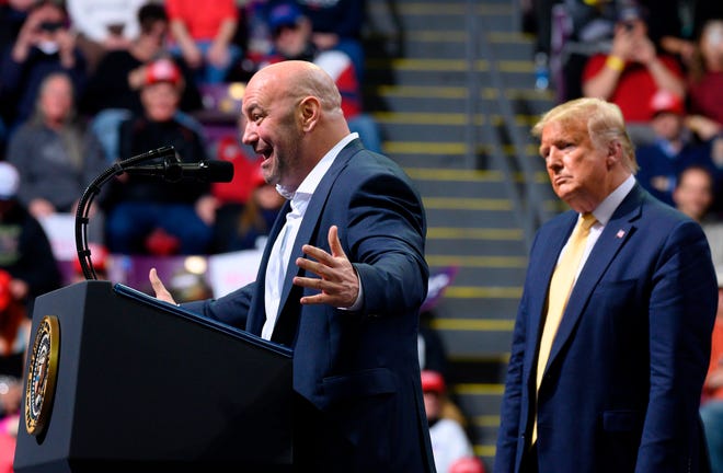 US President Donald Trump (R) looks on as Ultimate Fighting Championship (UFC) President Dana White addresses a