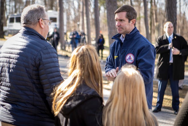 Gov. Andy Beshear talks with residents as he tours pull-behind campers that have been set up in Dawson Springs and Mayfield to provide relief housing for residents displaced by the December 2021 tornado. Jan. 28, 2022