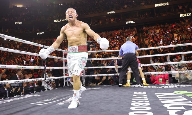 LAS VEGAS, NEVADA - MARCH 30: Isaac Cruz celebrates after defeating WBA super lightweight champion Rolando Romero at T-Mobile Arena on March 30, 2024 in Las Vegas, Nevada. Cruz won the title with an eighth-round TKO. (Photo by Steve Marcus/Getty Images)