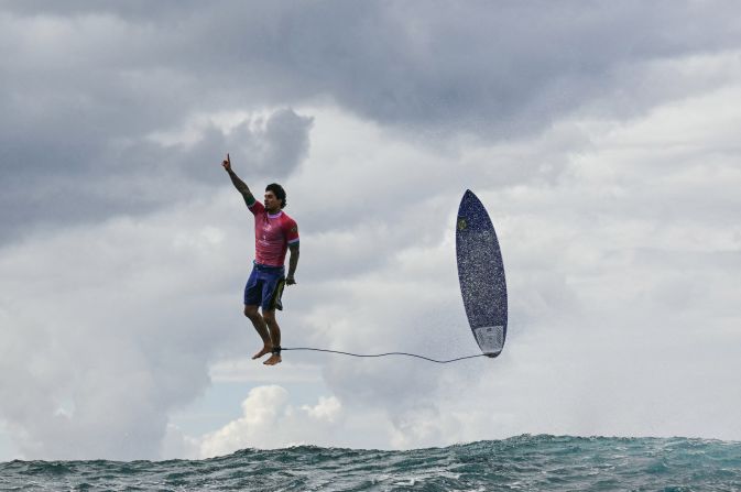 Brazilian surfer Gabriel Medina leaps from his surfboard and raises his finger in the air as he celebrates a near-perfect 9.90-scoring wave on Monday, July 29. It was the highest-scoring wave in Olympic history.