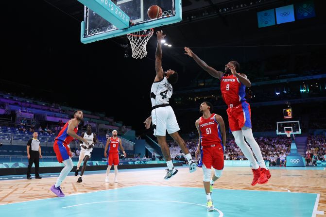 South Sudanese basketball player Carlik Jones drives to the basket during a game against Puerto Rico on July 28. South Sudan claimed a historic victory in its first-ever Olympic men's game, winning 90-79.