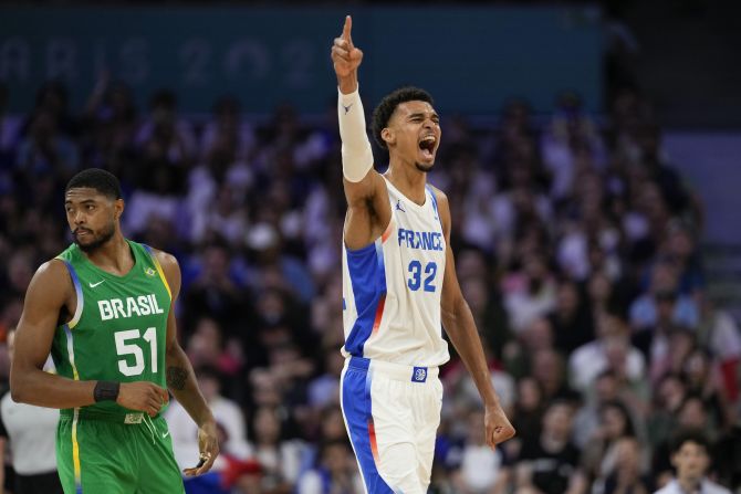 French basketball superstar Victor Wembanyama celebrates a Brazil turnover during the teams' opening game on July 27. Wembanyama had 19 points, nine rebounds, two assists, four steals and three blocks as France won 78-66.