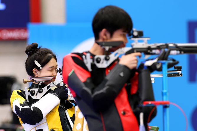 China’s Huang Yuting, left, competes in the 10-meter air rifle mixed-team shooting competition with Sheng Lihao on July 27. They won the first gold medal of the Paris Olympics.