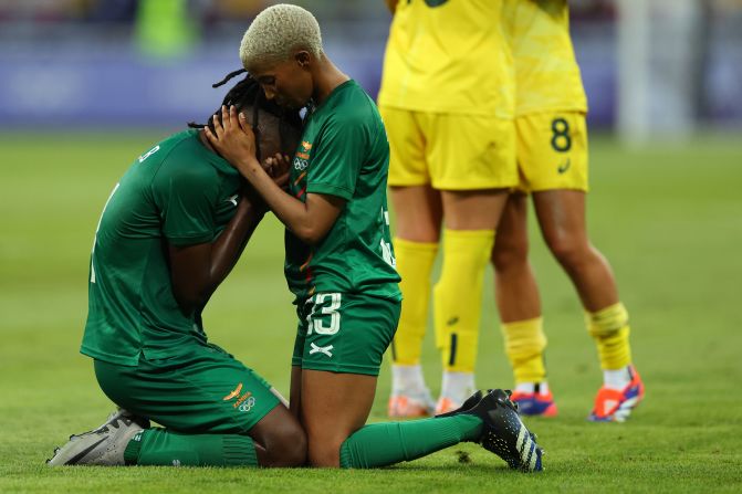 Zambia's Martha Tembo consoles teammate Barbra Banda after Australia came back from a 5-2 deficit to win 6-5 in their soccer match on July 28.