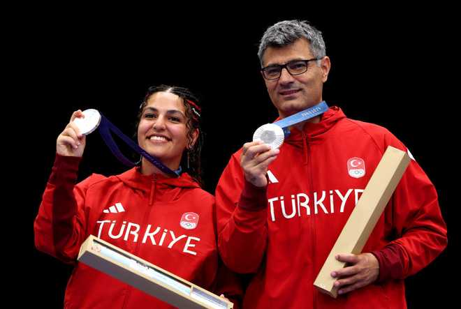 CHATEAUROUX, FRANCE - JULY 30: Silver medalists Sevval Ilayda Tarhan and Yusuf Dikec of Team Turkiye pose on the podium during the Shooting 10m Air Pistol Mixed Team medal ceremony on day four of the Olympic Games Paris 2024 at Chateauroux Shooting Centre on July 30, 2024 in Chateauroux, France. (Photo by Charles McQuillan/Getty Images)