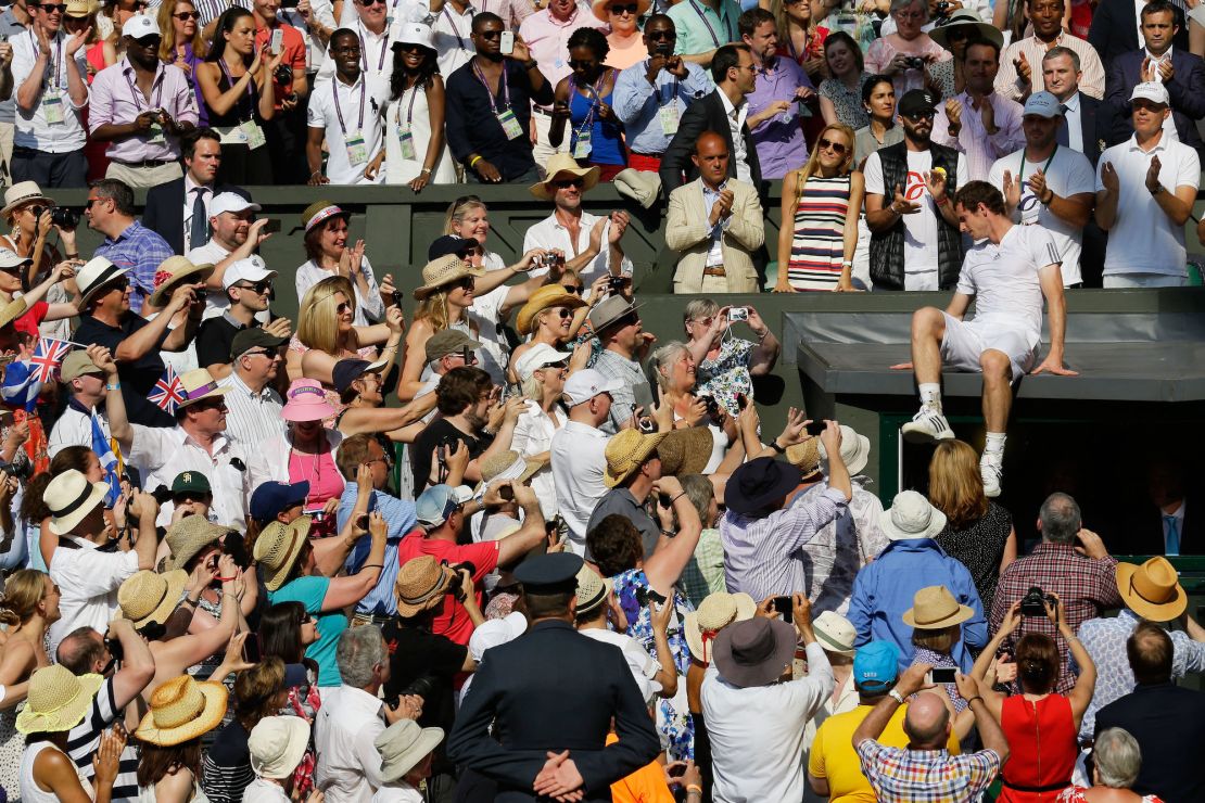 Murray climbs to his friends and family after winning the Wimbledon title in 2013.