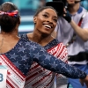 Simone Biles was all smiles with teammate Jordan Chiles after finishing her routine on the uneven bars during the women's gymnastics team final at the Olympic Games in Paris.