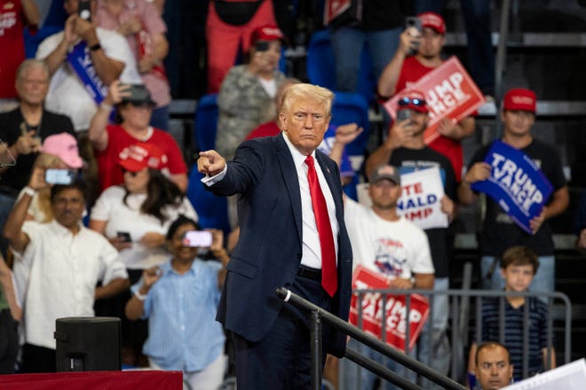 Former US President and 2024 Republican presidential candidate Donald Trump points to the crowd as he leaves after speaking during a campaign rally at the Georgia State University Convocation Center in Atlanta, Georgia, on August 3, 2024.