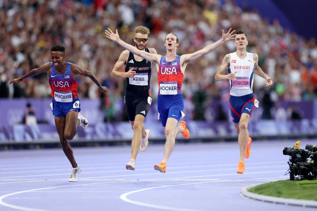 Bronze medalist Yared Nuguse of the U.S. (L-R), silver medalist Josh Kerr of Great Britain, gold medalist Cole Hocker of the U.S. and Jakob Ingebrigtsen of Norway cross the finish line of the men's 1,500m final on Tuesday. Hocker set an Olympic record with the win.