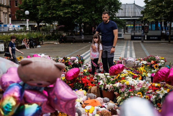 Members of the community arrive ahead of a vigil to remember the three young girls killed and several others seriously injured in a knife attack last week in Southport, England, on Aug. 5, 2024.