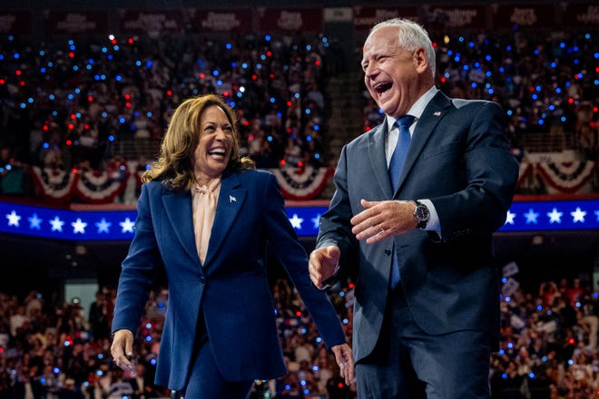 Democratic presidential candidate, U.S. Vice President Kamala Harris and Democratic vice presidential nominee Minnesota Gov. Tim Walz walk out on stage together during a campaign event on August 6, 2024 in Philadelphia, Pennsylvania.