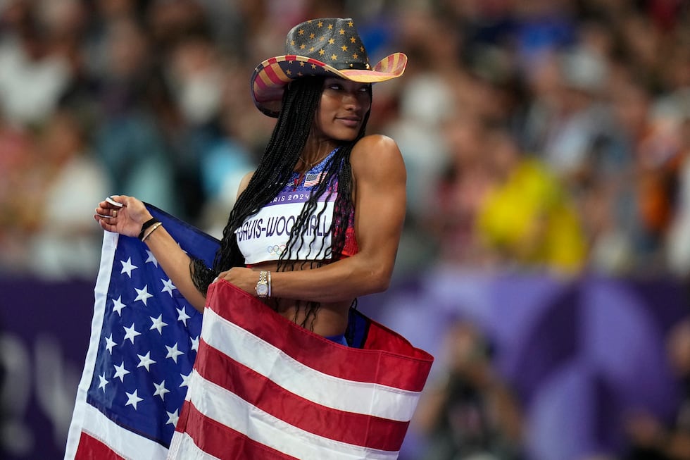 Tara Davis-Woodhall, of the United States, celebrates after winning the women's long jump...