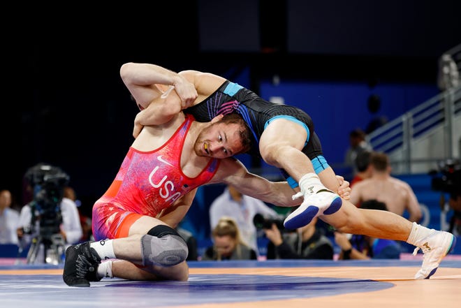 Spencer Lee (USA) defeats Wanhao Zou (CHN) in a men’s freestyle 57kg 1/8 final match during the Paris 2024 Olympics. Lee, a former Hawkeye, has earned a trip to Friday's gold medal match following a 3-0 showing Thursday.