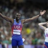 Rai Benjamin of the U.S. celebrates after winning gold ahead of silver medalist Karsten Warholm of Norway, seen behind him, in the 400-meter hurdles final at the Paris Olympics on Friday.