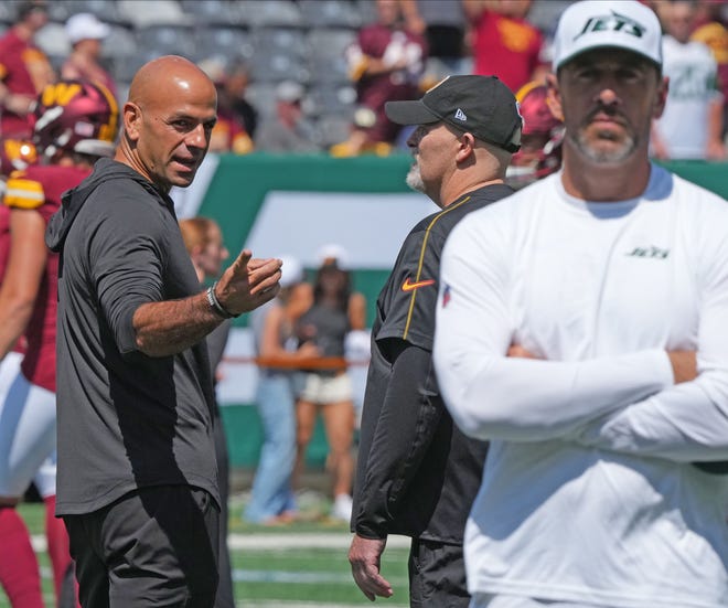 East Rutherford, NJ -- August 10, 2024 -- Jets head coach Robert Salih with Washington head coach Dan Quinn watching Aaron Rodgers during pre game warm ups as the Washington Commanders came to MetLife Stadium to play the New York Jets in the first press season game of the 2024 season.