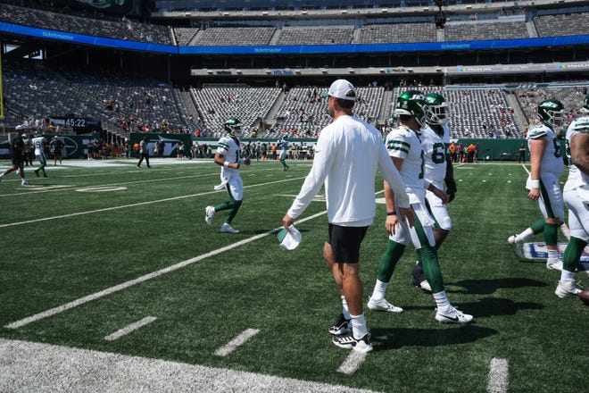 East Rutherford, NJ -- August 10, 2024 -- Aaron Rodgers, who wasnÕt dressed to play, during pre game warm ups as the Washington Commanders came to MetLife Stadium to play the New York Jets in the first press season game of the 2024 season.