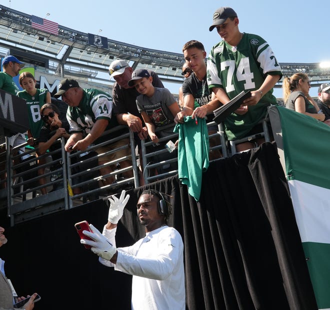 East Rutherford, NJ -- August 10, 2024 -- Will McDonald IV of the Jets with fans during pre game warm ups as the Washington Commanders came to MetLife Stadium to play the New York Jets in the first press season game of the 2024 season.