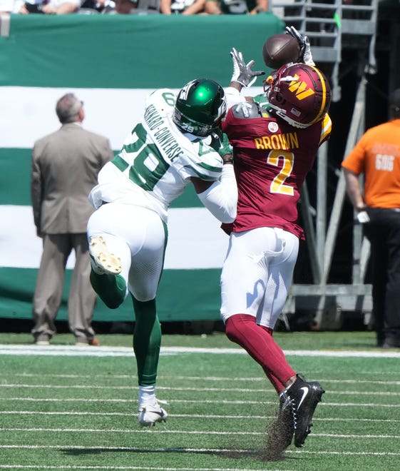 East Rutherford, NJ -- August 10, 2024 -- Carrick Bernard-Converse of the Jets canÕt prevent this long reception by Dyami Brown of the Commanders as the Washington Commanders came to MetLife Stadium to play the New York Jets in the first press season game of the 2024 season.