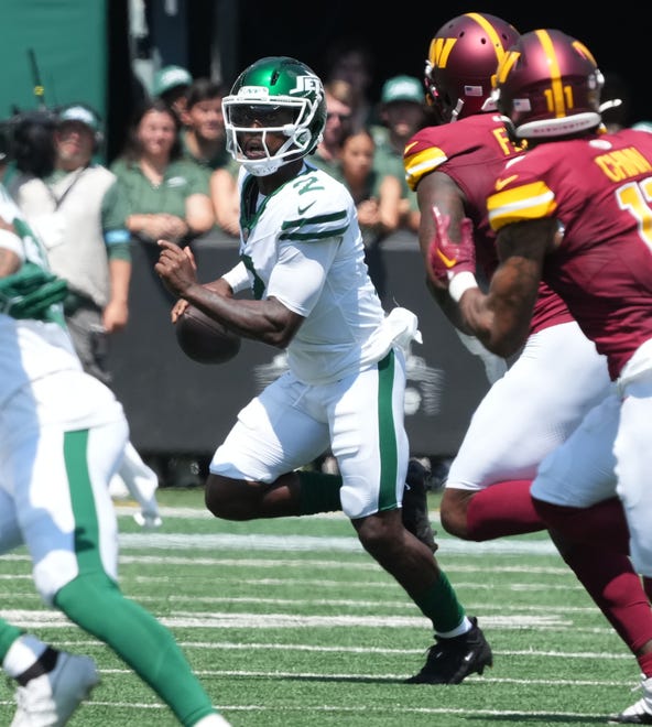 East Rutherford, NJ -- August 10, 2024 -- Jets quarterback Tyron Taylor is chased out of the pocket as the Washington Commanders came to MetLife Stadium to play the New York Jets in the first press season game of the 2024 season.