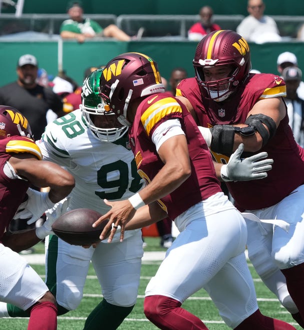 East Rutherford, NJ -- August 10, 2024 -- Bruce Header of the Jets sacks Marcus Mariota of the Commanders in the first half as the Washington Commanders came to MetLife Stadium to play the New York Jets in the first press season game of the 2024 season.